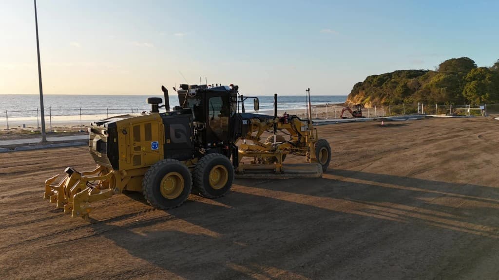 Motor grader on a coastal job site